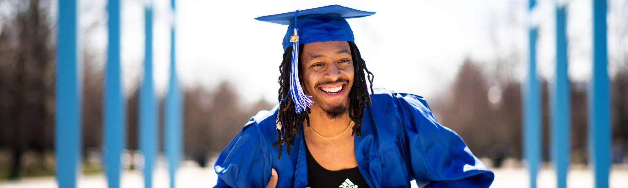 Graduating student celebrating under the Links